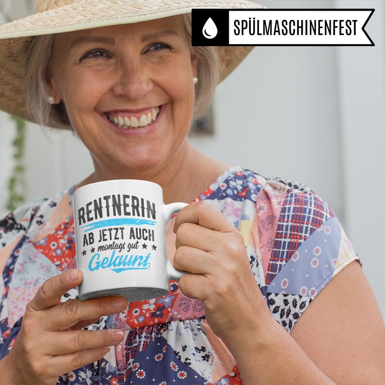May include: White ceramic mug with a blue and black design that says "Rentnerin ab jetzt auch montags gut gelaunt".