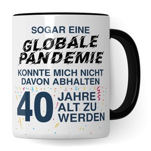 May include: White ceramic mug with a black handle. The mug has a black rim and features a birthday message that reads "Even a global pandemic couldn't stop me from turning 40 years old". The text is in black and the number 40 is in blue. The background is white with colorful confetti.