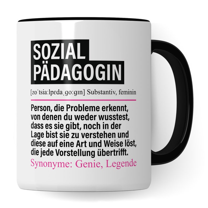 May include: White ceramic mug with a black handle. The mug has black text that reads "SOZIAL P&Auml;DAGOGIN" and a definition in German. The definition reads "[zo'tsia:lpeda, go:gın] Substantiv, feminin Person, die Probleme erkennt, von denen du weder wusstest, dass es sie gibt, noch in der Lage bist sie zu verstehen und diese auf eine Art und Weise l&ouml;st, die jede Vorstellung &uuml;bertrifft. Synonyme: Genie, Legende"