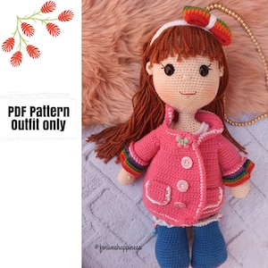 May include: A crochet doll outfit pattern, featuring a pink jacket with rainbow trim, blue pants, and white boots. The pattern is available as a PDF download and is for the outfit only.