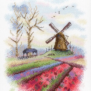 Könnte beinhalten: Ein Kreuzstichmuster mit einer Windmühle mit braunem Dach und weißen Flügeln, umgeben von Bäumen und Blumen. Der Himmel ist blau mit weißen Wolken und Vögeln, die darüber fliegen.