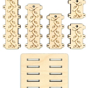 May include: Set of five wooden pieces with a vine and leaf design. The pieces are different sizes and can be used to create a decorative wall hanging or other craft project.