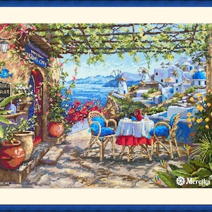 May include: A cross-stitch pattern depicting a cafe with a blue and white awning, tables and chairs, and a view of the sea. The cafe is surrounded by lush greenery and flowers. The text "Toukla Taverna Cafe" is visible on the awning.