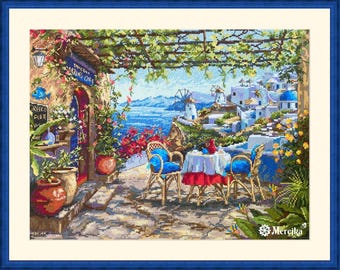 May include: A cross-stitch pattern of a cafe with a blue and white awning, tables and chairs, and a view of the ocean. The cafe is surrounded by lush greenery and flowers. The text "Toukla Taverna Cafe" is visible on the awning.