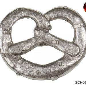 May include: A silver-coloured metal pretzel charm with a detailed design. The charm is made in Germany.