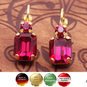 Könnte beinhalten: Ein Paar vergoldete Ohrringe mit einem roten Kristall in Form eines Rechtecks. Die Ohrringe sind in Deutschland hergestellt und hypoallergen.