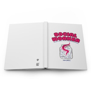 May include: An open book with a white cover and a pink and white illustration of a jar filled with words. The title of the book is "Social Worker: The Perfect Formula to Create a Social Work Professional" by Lisa Smith.