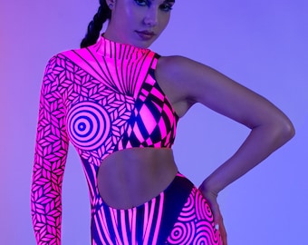 May include: A neon pink and black bodysuit with geometric patterns. The one-piece garment features a high neckline, a long sleeve on one arm, and a cut-out design at the waist. The outfit is paired with a pink garter.