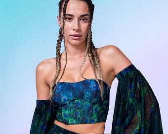 May include: A two-piece set featuring a strapless corset-style top and matching sheer shorts with a vibrant peacock feather print in shades of blue and green. The outfit includes long, flowing, detached off-the-shoulder sleeves with ruffled edges.