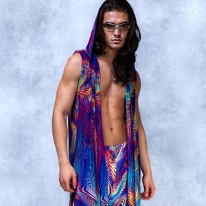 May include: A sleeveless hooded garment and matching bottoms with a vibrant, abstract pattern in shades of blue, purple, and yellow. The outfit is worn by a person with long, dark hair and sunglasses.
