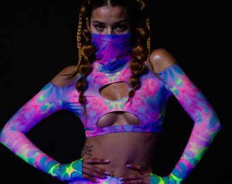 May include: A tie-dye crop top and matching sleeves in shades of pink, blue, and green. The top has cut-out details and a matching face covering. The sleeves extend to the hands, with fingerless glove details.