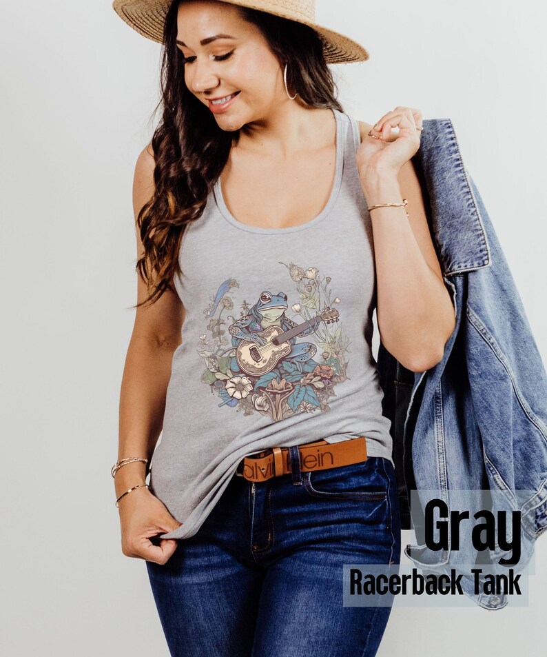 May include: Gray racerback tank top with a graphic of a frog playing a guitar in a field of flowers.