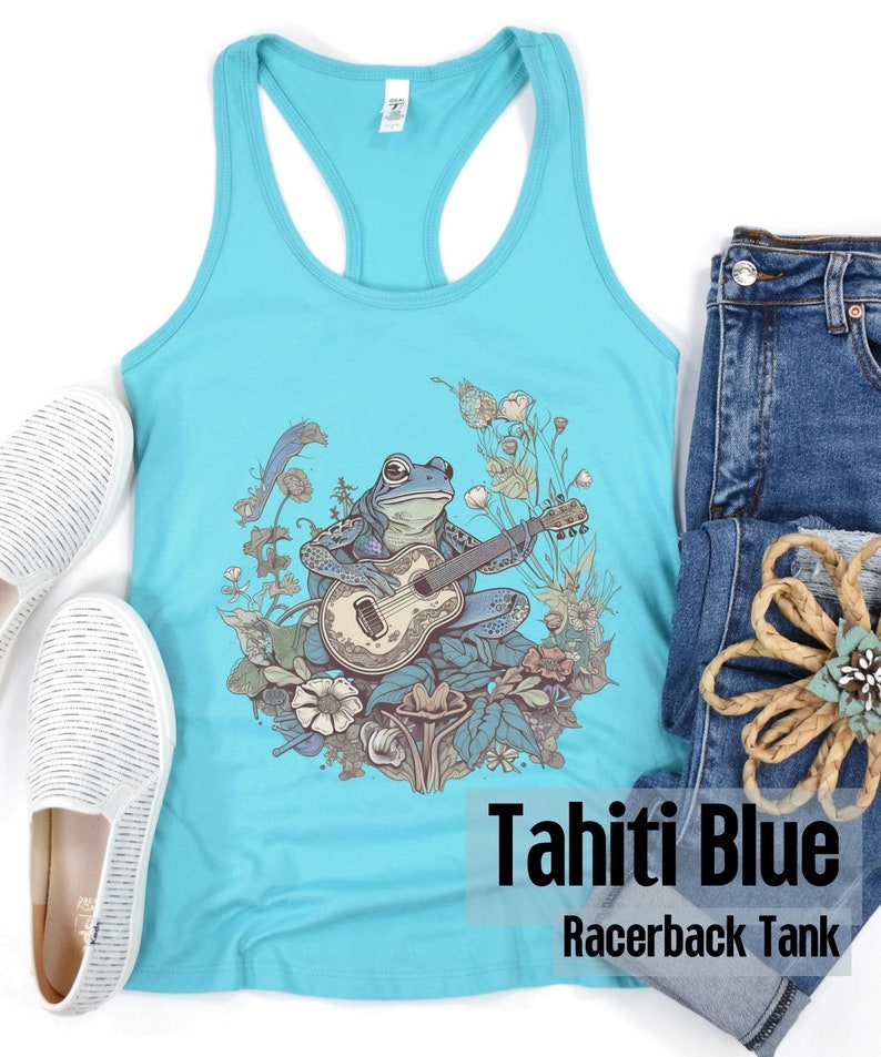 May include: A turquoise blue racerback tank top with a graphic of a frog playing a guitar surrounded by flowers. The text "Tahiti Blue Racerback Tank" is printed on the bottom of the shirt.
