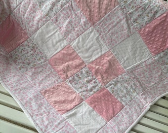 Handmade pink baby quilt with personalization option.