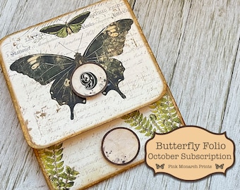 May include: A brown and cream butterfly folio with a black and white butterfly design and the text "Butterfly Folio October Subscription Pink Monarch Prints".