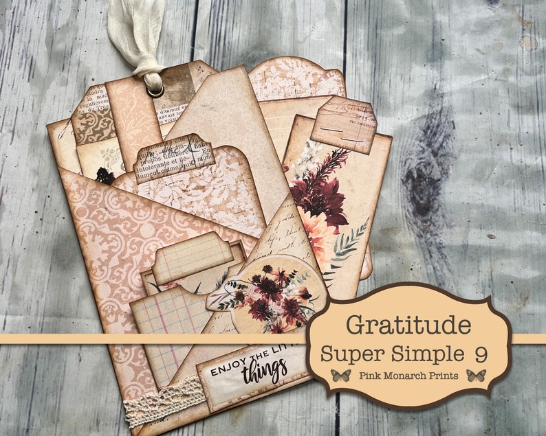 May include: A set of nine vintage-style paper tags with a floral design and the text "Gratitude Super Simple 9" and "Pink Monarch Prints". The tags are layered and have a distressed look.