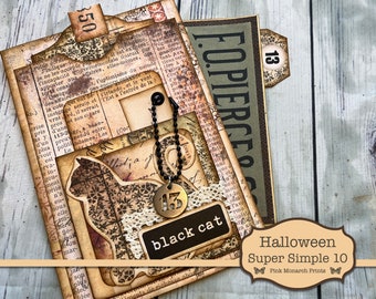 May include: A Halloween-themed scrapbook page with a black cat silhouette, a black and gold charm with the number 13, and the text "black cat". The page is decorated with vintage-style paper and embellishments.