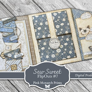 May include: A decorative paper craft folder featuring vintage-style floral patterns in blue and cream. The design includes stacked envelope motifs, butterfly illustrations, and circular labels with text like Town General Store Trade Mark.