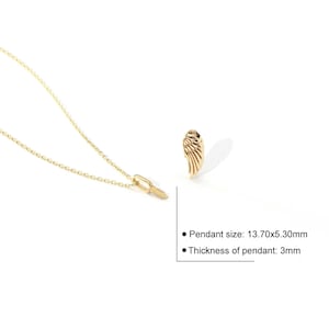 May include: A gold-colored necklace with a wing-shaped pendant. The pendant measures 0.54 x 0.21 inches and is 0.12 inches thick. The necklace is on a white background.