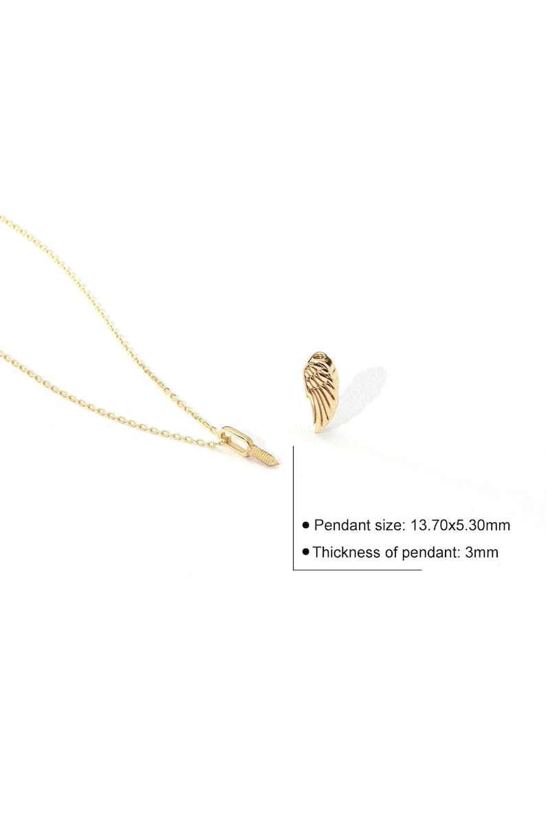 May include: A gold-colored necklace with a wing-shaped pendant. The pendant measures 0.54 x 0.21 inches and is 0.12 inches thick. The necklace is on a white background.