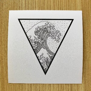May include: A black and white illustration of a wave, enclosed within a black triangle. The artwork is reminiscent of the iconic Great Wave off Kanagawa. The image is on a white square, with the text "fern + akye" in a small triangle in the bottom right corner.