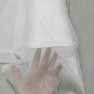 May include: White sheer fabric with a delicate, fine mesh texture. The fabric is soft and lightweight, with a subtle sheen.