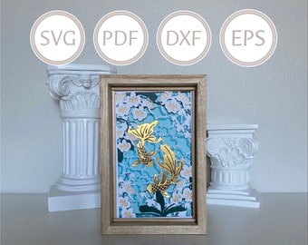 May include: A framed print of a blue and white floral design with two gold fish. The fish are stylized and have a delicate, almost paper-like appearance. The print is in a light wood frame.