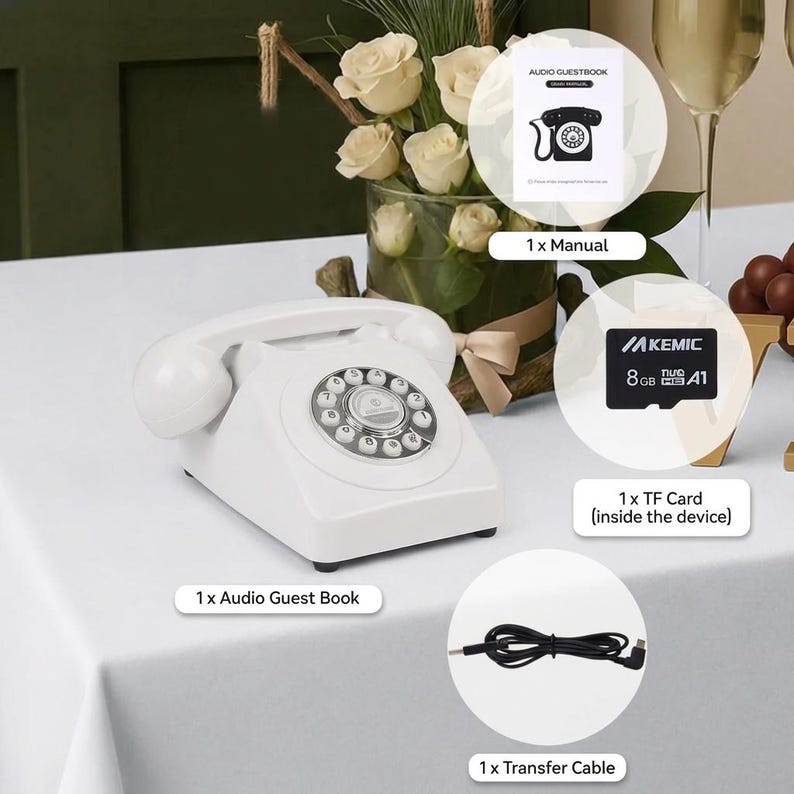 May include: A white retro telephone with a rotary dial is displayed on a white surface. The image includes a manual, a TF card, and a transfer cable. A floral arrangement and a champagne glass are in the background.