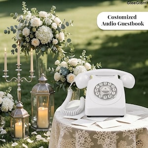 May include: A white vintage rotary phone is displayed on a lace-covered table, with the text "Customized Audio Guestbook". The image features floral arrangements, candles, and lanterns, suitable for a wedding or event.