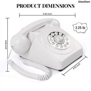 May include: A white retro rotary phone with a dial pad and handset. The phone is 24 cm wide, 21.5 cm tall, and 12.5 cm deep. It weighs 1.02 kg. The text "PRODUCT DIMENSIONS" is at the top.