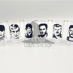 May include: Set of six clear glass shot glasses with black and white silhouette images of famous serial killers. The images include Ted Bundy, John Wayne Gacy, Jeffrey Dahmer, Ed Gein, and others.