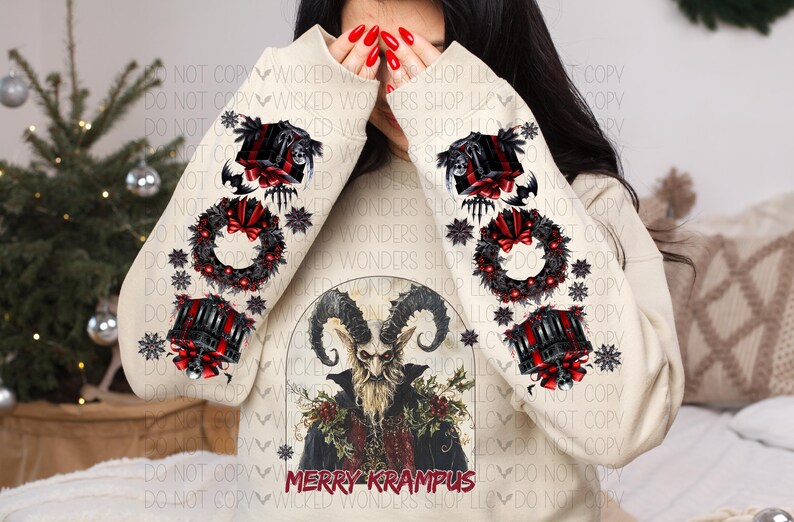 May include: A cream-colored sweatshirt with a festive Christmas design featuring a horned figure with a beard and the text "Merry Krampus". The sleeves have a repeating pattern of wreaths, candles, and snowflakes.