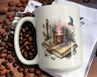 May include: White ceramic mug with a colorful illustration of a book, a cauldron, a candle, and a butterfly. The illustration is in a whimsical style and features a magical theme.