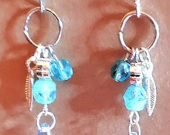Bohemian style earrings, blue and clear glass beads, silver feather charm.