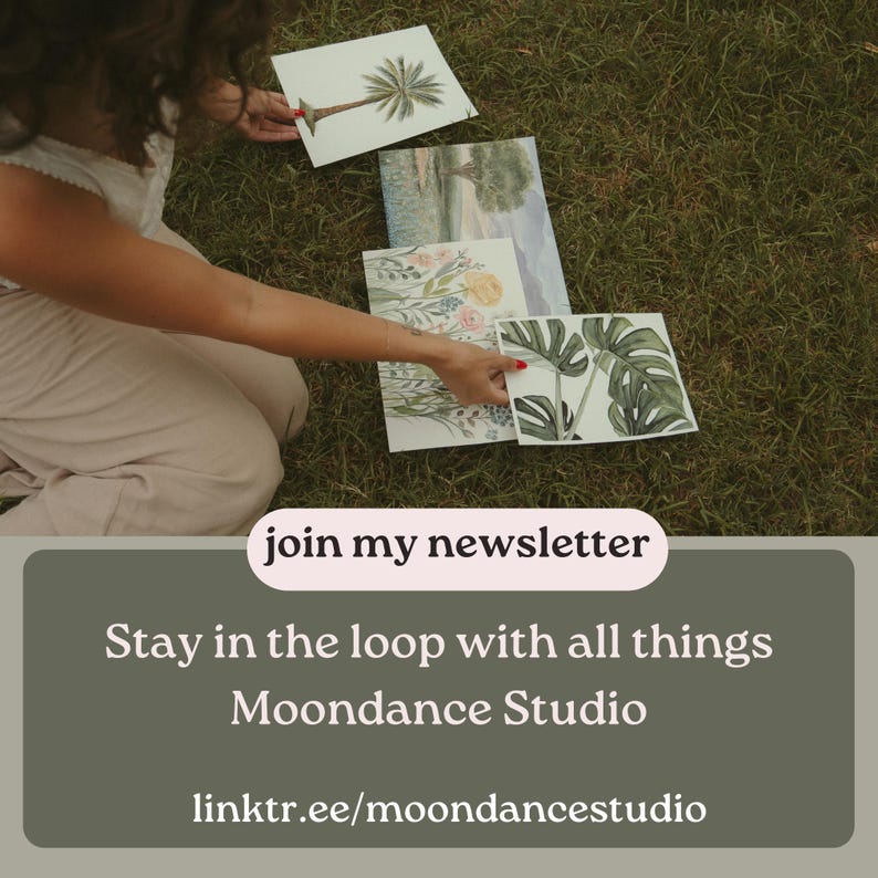 May include: A woman is holding up watercolor paintings of plants and trees. The paintings are on white paper with a light green background. The text "join my newsletter" is on a pink banner. The text "Stay in the loop with all things Moondance Studio" is on a green banner. The text "linktr.ee/moondancestudio" is on a white banner.