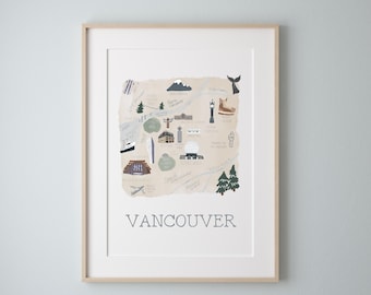May include: A beige illustrated map of Vancouver, Canada, with landmarks and icons. The map is framed in a light wood frame and has the word "VANCOUVER" printed in black at the bottom.