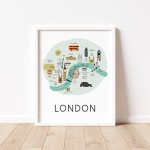 Puede incluir: Una impresión enmarcada en blanco de un mapa de Londres, Inglaterra. El mapa está ilustrado con monumentos e iconos, incluyendo el Big Ben, el London Eye y el Tower Bridge. El mapa está rodeado por un círculo azul claro con el texto "River Thames" en el centro. El texto "LONDON" está impreso en negro en la parte inferior de la impresión.