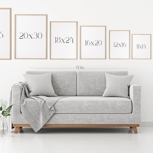 May include: A white wall with a gray couch and a set of framed prints in various sizes. The prints are labeled with their dimensions in inches, starting with 24x36 and decreasing in size to 5x7. The couch is 80 inches wide.