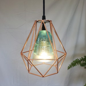 Lite Blue Bee Hive Glass Electric Insulator Pendant Light inside a coper geometric cage Lights