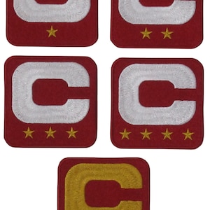 May include: Five embroidered patches featuring a white letter "C" on a red background with gold stars. One patch features a gold letter "C" on a red background with gold stars.