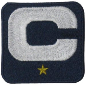 May include: Embroidered patch featuring a large white letter "C" on a navy blue background. A small gold star is positioned below the letter. The patch has a square shape with rounded corners.