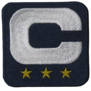 May include: Embroidered patch featuring a large white letter "C" on a navy blue background. Below the letter are three gold stars. The patch has a square shape with rounded corners.