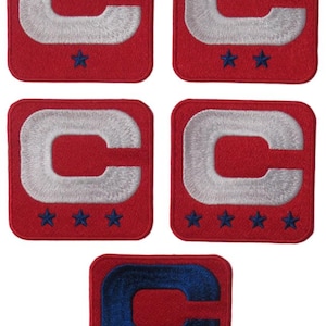 May include: Five embroidered patches with a red background and a white "C" design. Each patch has a different number of blue stars at the bottom. The bottom patch has a blue "C".