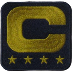 May include: Embroidered patch featuring a large gold letter "C" on a navy blue square. Below the letter are four gold stars. The patch has a textured appearance, suggesting it is made of fabric.