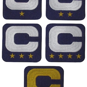 May include: Five embroidered patches featuring a navy blue background with a white "C" and gold stars. One patch has a gold "C". The patches are square and have a stitched border.