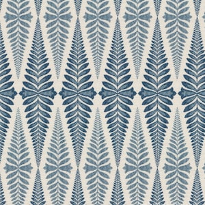 May include: A repeating pattern of stylized blue fern leaves on a cream-colored background. The leaves are arranged in a diamond-like formation, creating a symmetrical and decorative design. The fabric has a textured appearance.