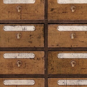 May include: A set of eight wooden drawers with white labels and metal handles. The drawers are arranged in two rows of four, and the wood has a distressed, vintage look.
