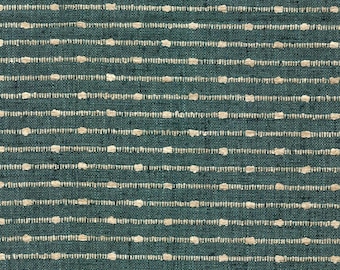 May include: A dark teal fabric featuring a repeating pattern of horizontal lines composed of small, raised beige dots. The textile has a visible woven texture with consistent spacing between the linear elements across the entire surface.