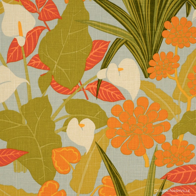 May include: A floral fabric design featuring white calla lilies, orange and red flowers, and green leaves on a light blue background. The fabric has a textured linen look.