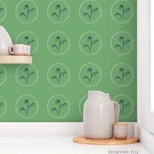May include: Green wallpaper with a repeating pattern of blue floral designs inside white circles. A white pitcher, small cup, and a wooden shelf with a mug are in the foreground. The Etsy shop name, DesignNash.Etsy, is at the bottom.